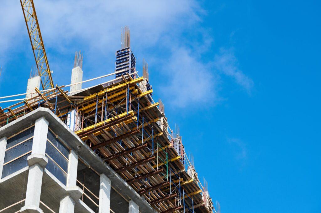 Construction of new building with reinforced concrete floors, blue sky copy space